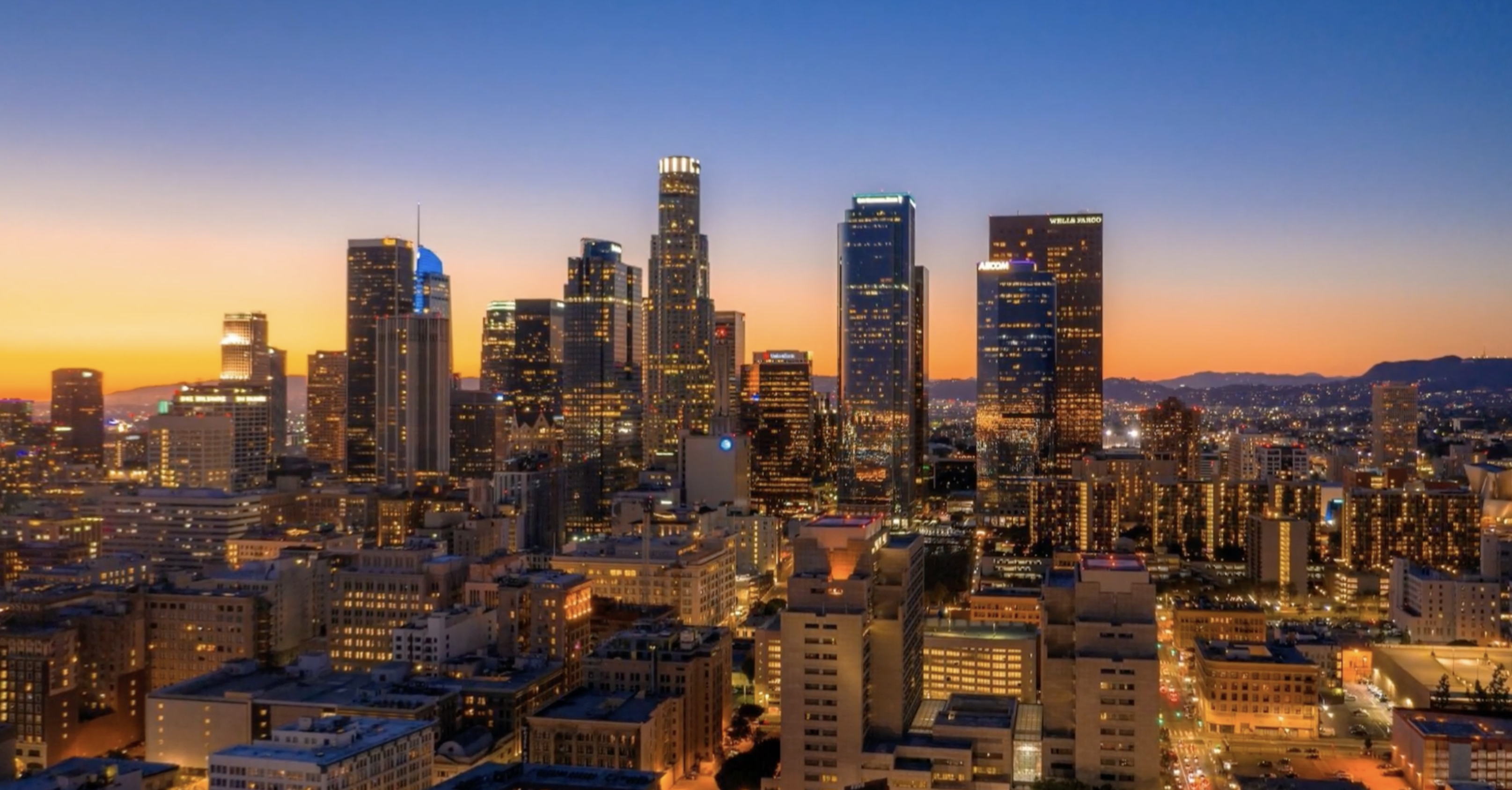 Downtown Los Angeles skyline at sunset with Live Scan fingerprinting service branding
